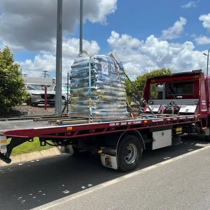 Pallets of freight on red tow truck