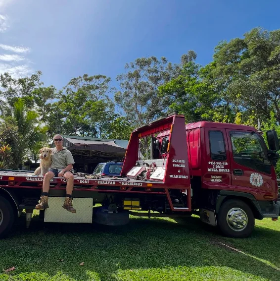 Scamps Towing operator Steve and Scamp the Labrador sitting on the truck